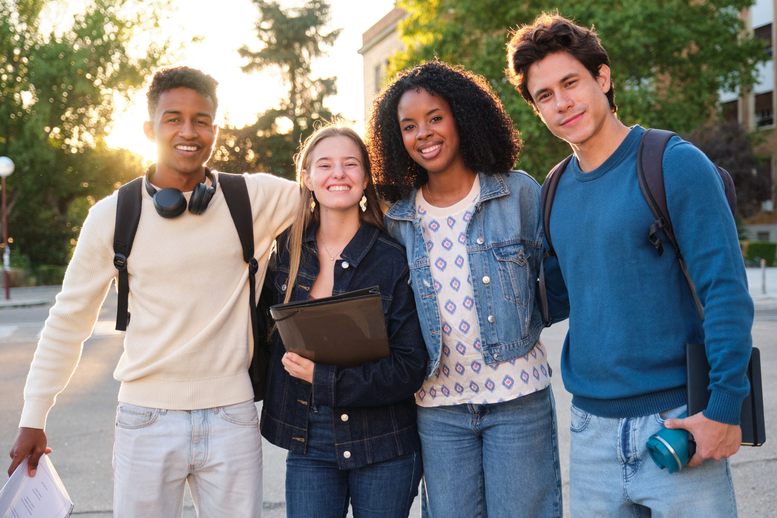 Diverse group of college students smiling on campus walking